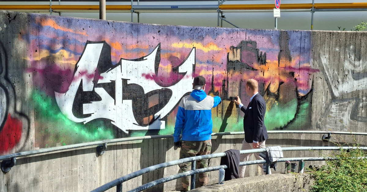 Kaufbeurens Kulturreferent Andreas Bauer (rechts) zusammen mit Graffiti-Künstler Lars Trautmann an der neuen Fläche - dem Rondell zur Tiefgarage am Berliner Platz

Foto: Christoph Rothe/Stadt Kaufbeuren